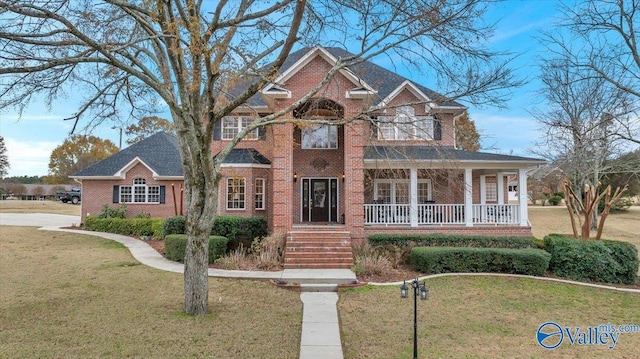 view of front of home featuring covered porch and a front yard