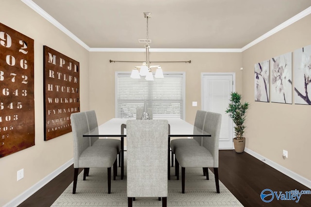 dining space with hardwood / wood-style flooring, a chandelier, and ornamental molding