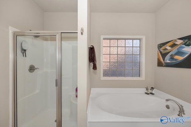 bathroom featuring independent shower and bath