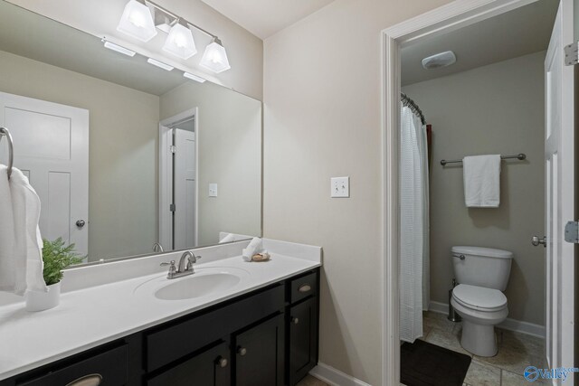 bathroom with double sink vanity, a bath, and tile patterned flooring