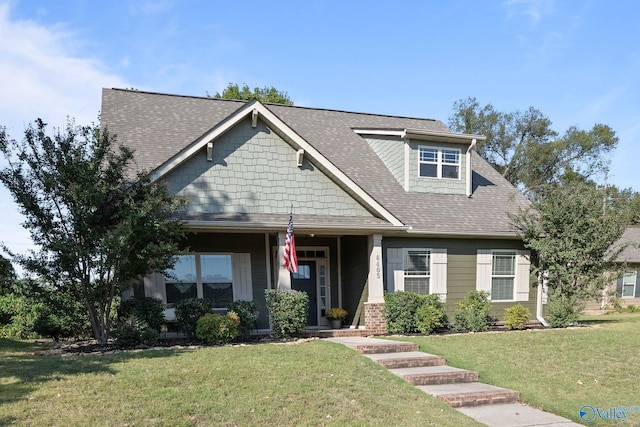 view of front facade with a front lawn and covered porch