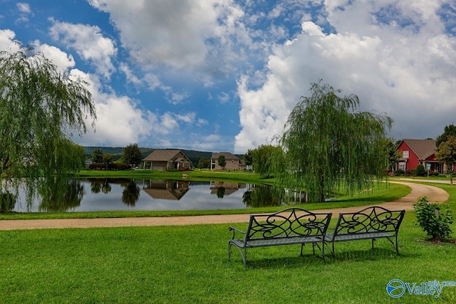 view of home's community featuring a water view and a yard