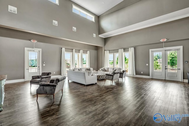 living room featuring high vaulted ceiling, french doors, and dark hardwood / wood-style floors