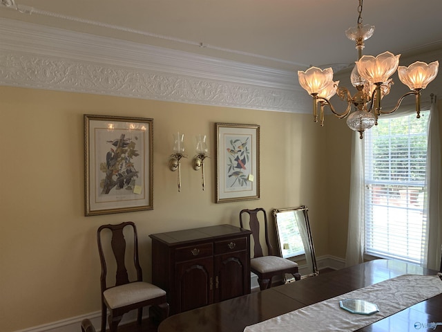 dining space featuring baseboards, crown molding, and an inviting chandelier