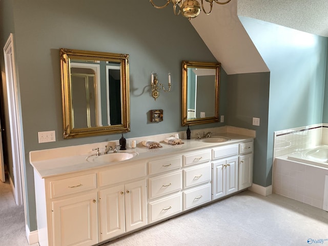 full bathroom with double vanity, a garden tub, and a sink