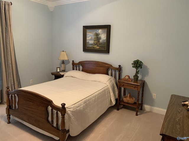 bedroom featuring light colored carpet, crown molding, and baseboards