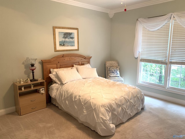 bedroom with baseboards, crown molding, and light colored carpet