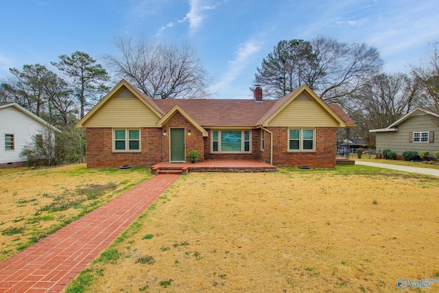 ranch-style home with brick siding, a chimney, crawl space, and a front yard