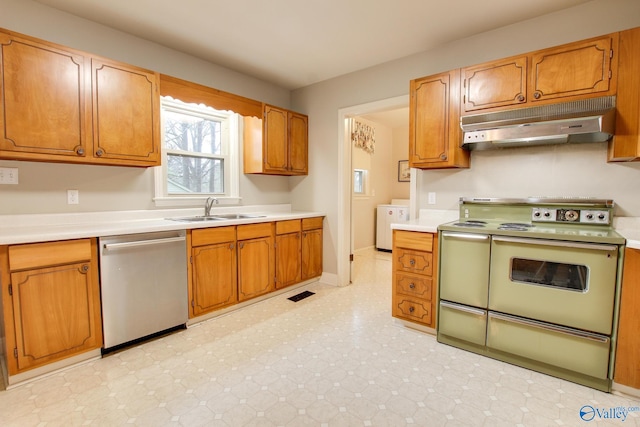 kitchen with light countertops, dishwasher, under cabinet range hood, a sink, and double oven range