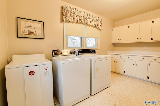 laundry area with independent washer and dryer, cabinet space, and light floors