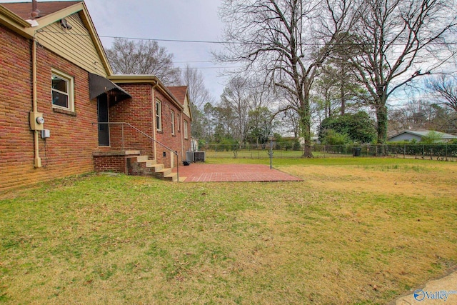 view of yard with fence, cooling unit, and a patio area