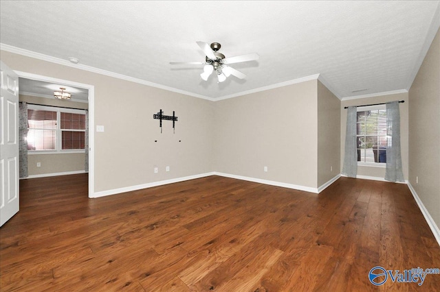 empty room with ornamental molding, wood-type flooring, baseboards, and a ceiling fan