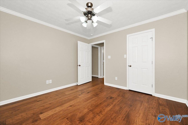 unfurnished bedroom featuring crown molding, wood finished floors, a textured ceiling, ceiling fan, and baseboards