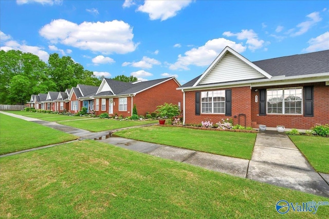 view of front of house with brick siding and a front yard