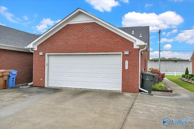 garage with concrete driveway