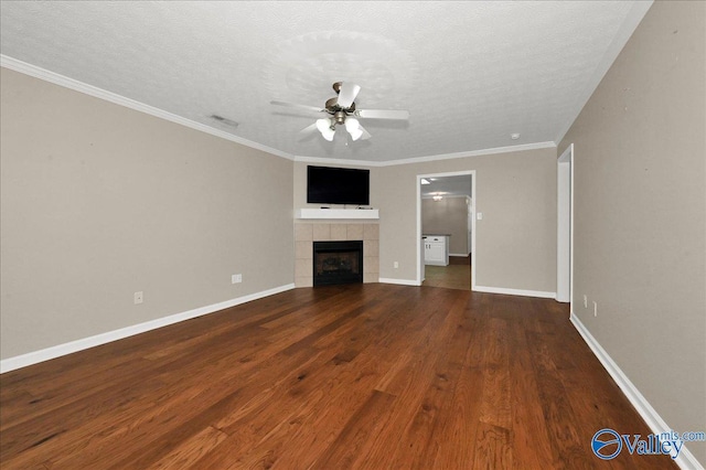 unfurnished living room featuring a textured ceiling, baseboards, wood finished floors, ceiling fan, and a fireplace