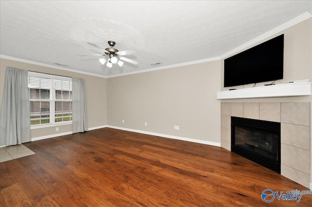 unfurnished living room with baseboards, a ceiling fan, wood finished floors, and a fireplace