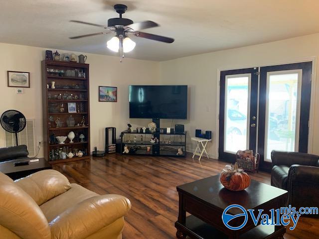 living room featuring hardwood / wood-style flooring, ceiling fan, and french doors