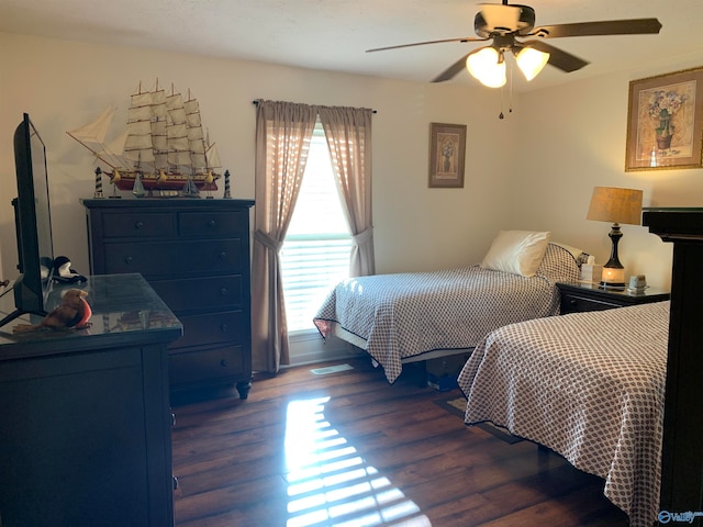 bedroom with dark wood-type flooring and ceiling fan