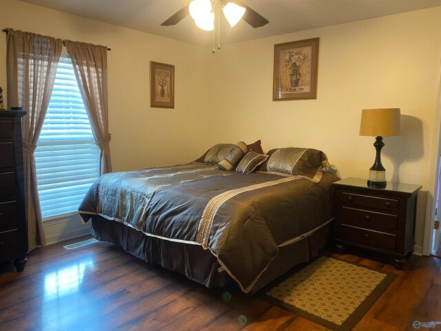 bedroom with dark wood-type flooring and ceiling fan