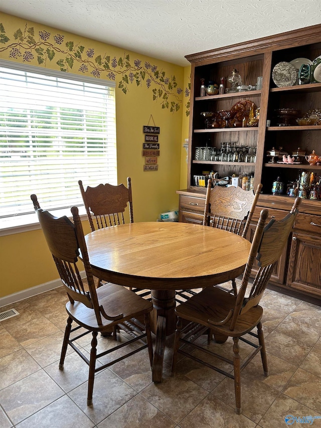 dining area featuring a textured ceiling