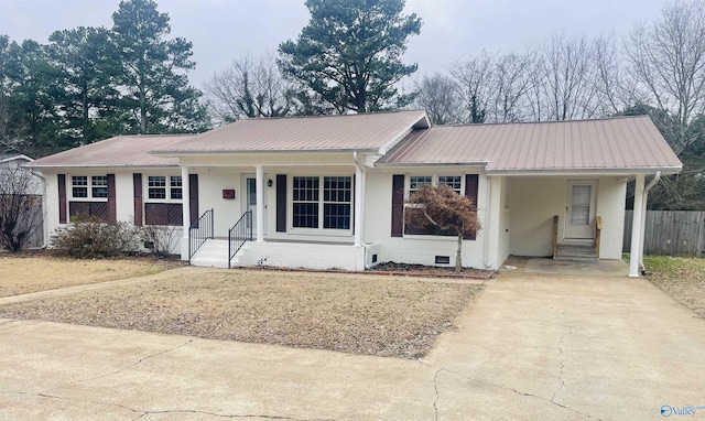 ranch-style home with a carport, covered porch, and a front lawn