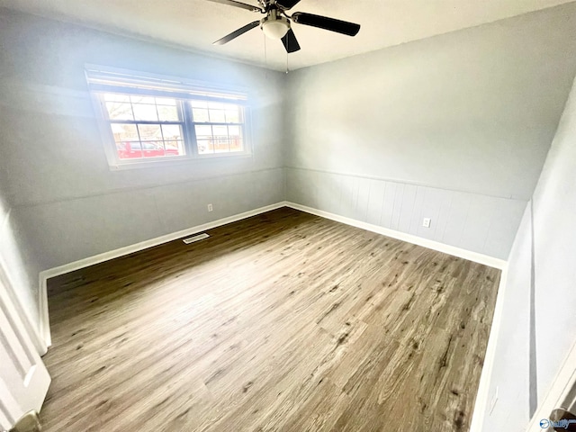 spare room featuring hardwood / wood-style flooring and ceiling fan