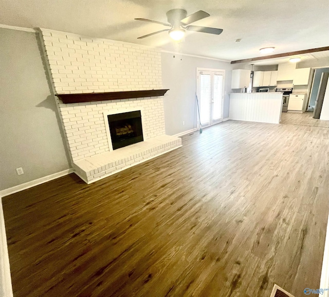 unfurnished living room featuring a fireplace, light hardwood / wood-style floors, and ceiling fan