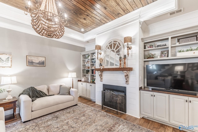 living room featuring a fireplace, wood finished floors, visible vents, wood ceiling, and crown molding