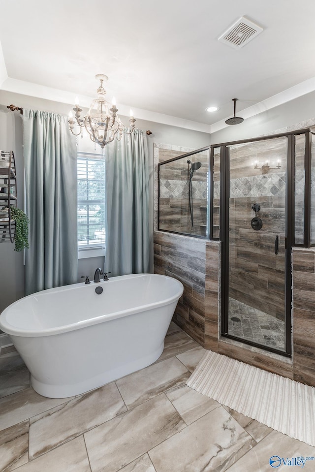 bathroom with a stall shower, visible vents, and a freestanding bath