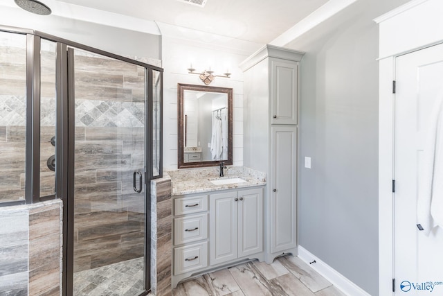 bathroom with hardwood / wood-style flooring, vanity, and a shower with shower door