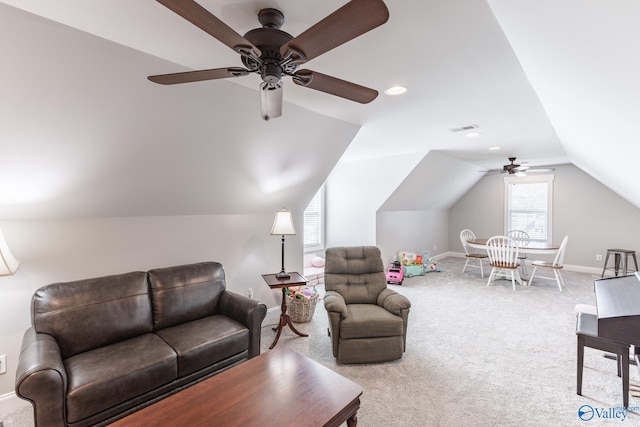 living area with ceiling fan, lofted ceiling, light carpet, visible vents, and baseboards