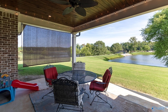 view of patio / terrace with ceiling fan and a water view