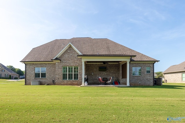 view of front of house with a patio area, central AC unit, and a front yard