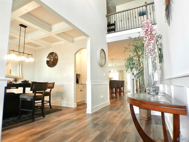 interior space featuring beamed ceiling, light hardwood / wood-style floors, and coffered ceiling