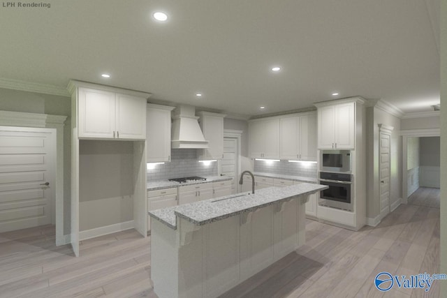 kitchen with light stone countertops, tasteful backsplash, premium range hood, white cabinetry, and stainless steel appliances