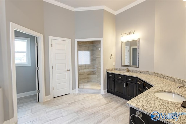 bathroom with an enclosed shower, vanity, and crown molding