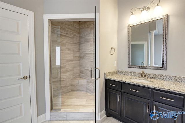 bathroom featuring vanity and a shower with shower door