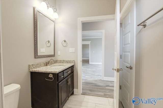 bathroom featuring vanity, toilet, and ornamental molding