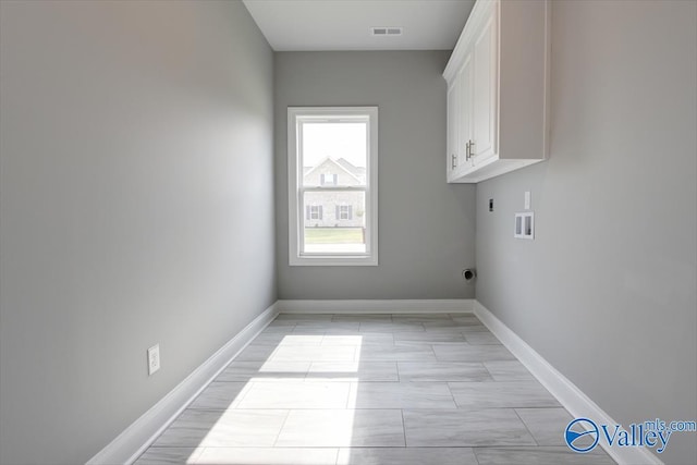 washroom featuring washer hookup, cabinets, and hookup for an electric dryer