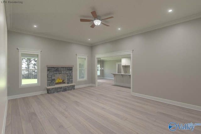 unfurnished living room with light hardwood / wood-style flooring, a stone fireplace, and ornamental molding