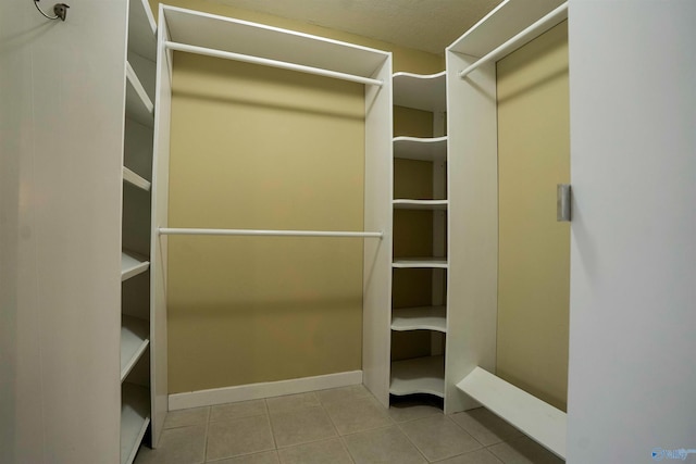 walk in closet with tile patterned flooring