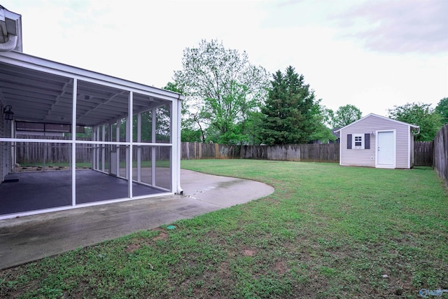 view of yard with a patio area, a fenced backyard, an outdoor structure, and a storage shed
