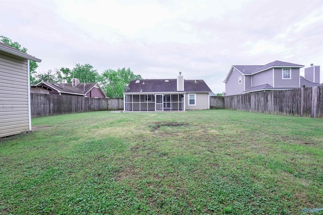 view of yard with a fenced backyard and a sunroom