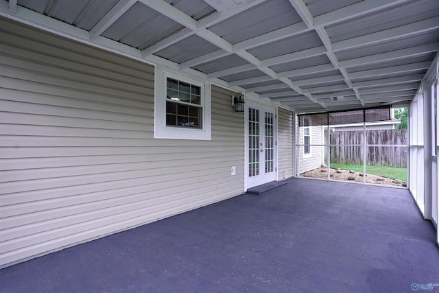 unfurnished sunroom with french doors