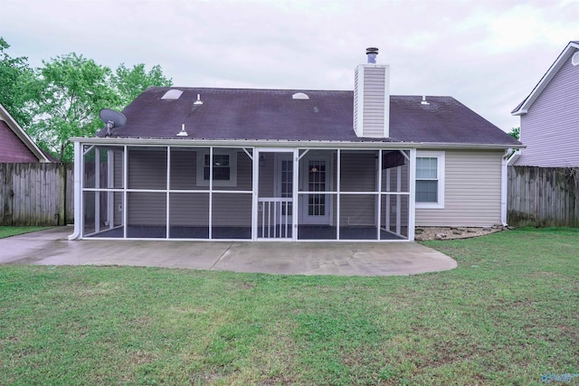 back of house with fence, a patio area, a chimney, and a sunroom