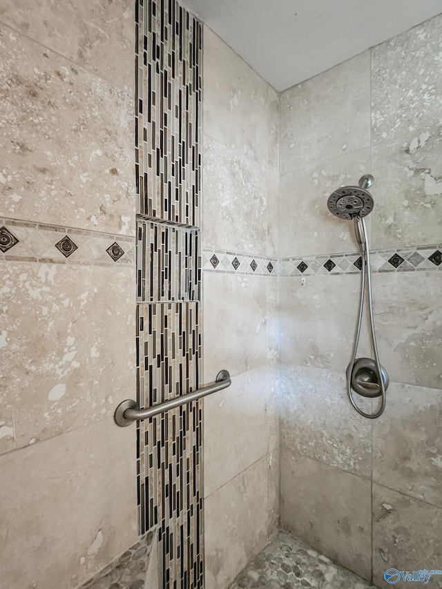 full bathroom with a tile shower