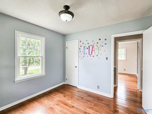 unfurnished bedroom featuring light wood-style floors and baseboards