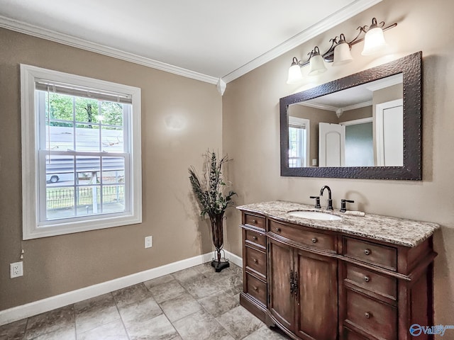 bathroom with ornamental molding, vanity, and baseboards