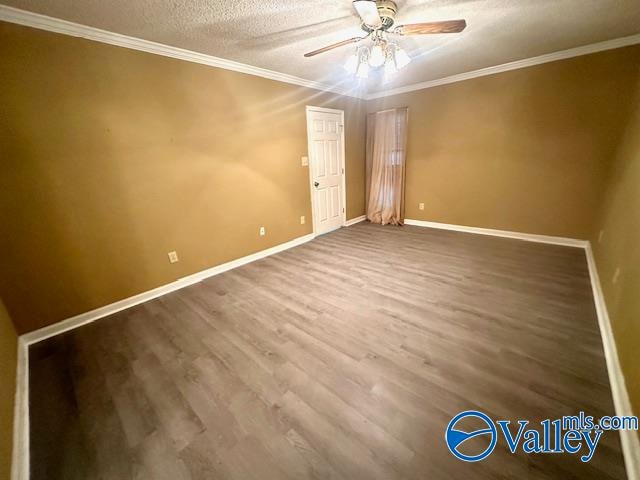 unfurnished room featuring ornamental molding, hardwood / wood-style flooring, a textured ceiling, and ceiling fan